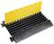 A cable protector in black and yellow with a hinged lid. Prevents damage and trip hazards on the floor area.