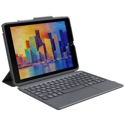 Tablet with a detachable keyboard, propped up. The screen displays a colourful cityscape with skyscrapers in the light of the setting sun.