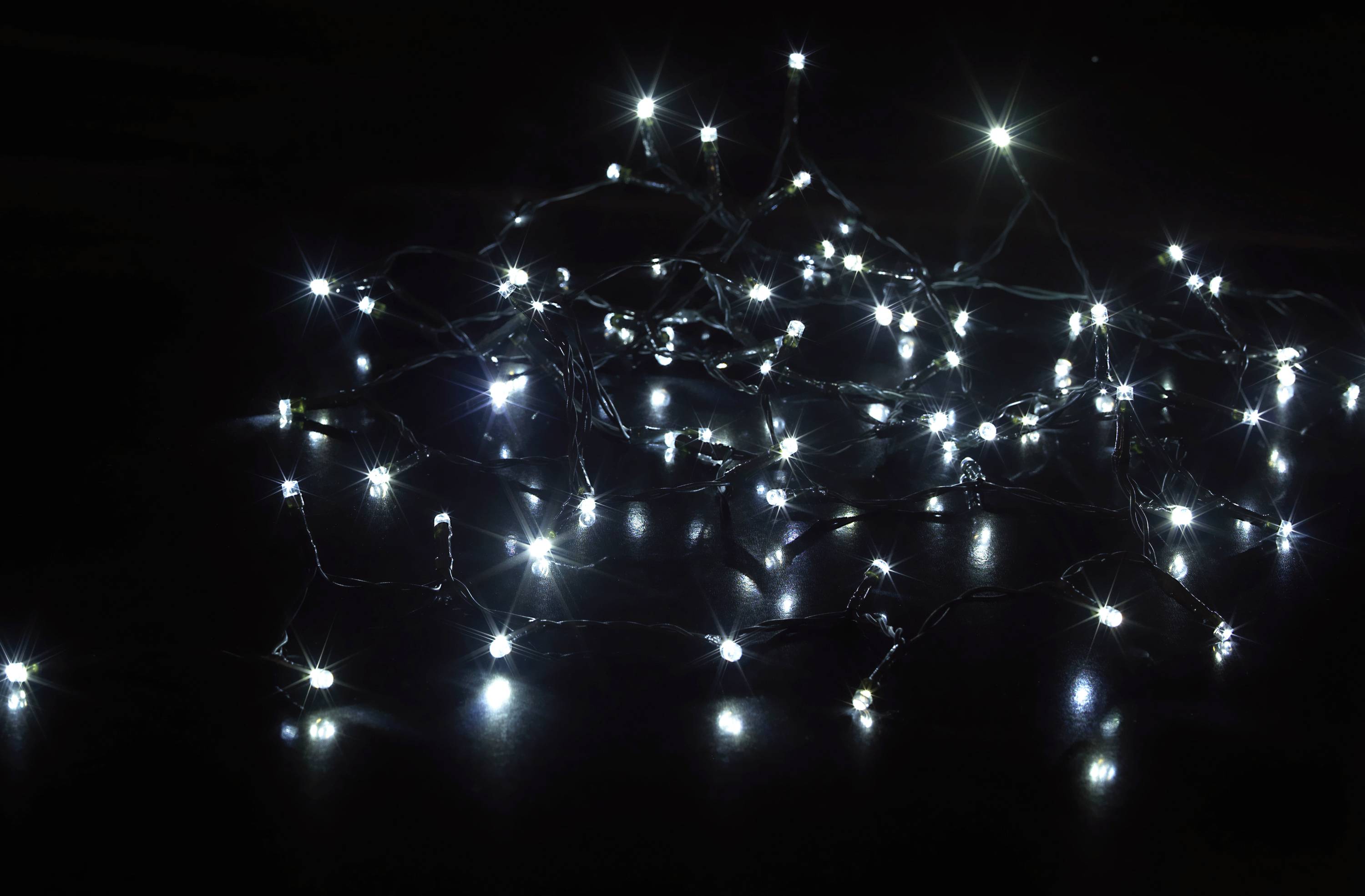 Several small blue LED lights are scattered and glowing against a dark background, creating a sparkling pattern.