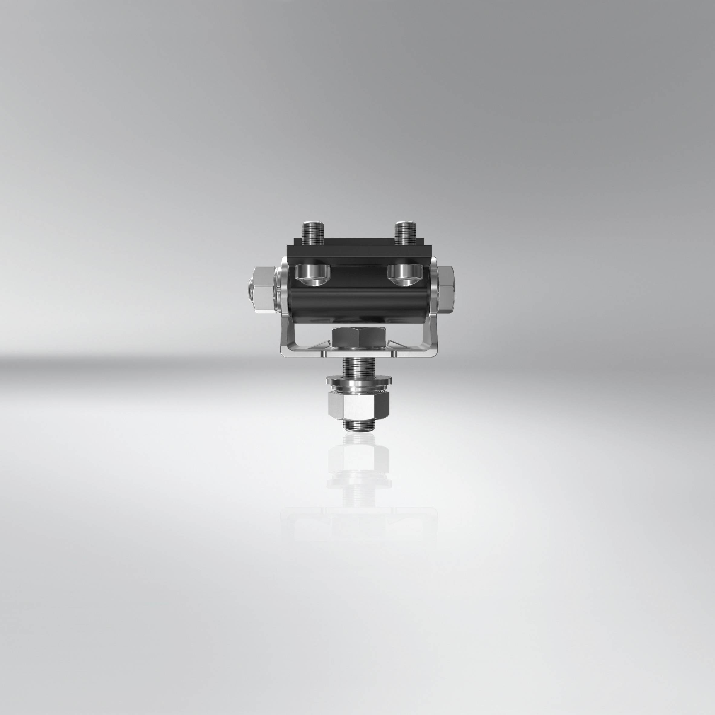 A metallic component with bolts and screws on a reflective surface, against a grey background.