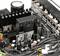 Close-up of an electronic circuit board with black, rectangular components and numerous wires establishing connections.