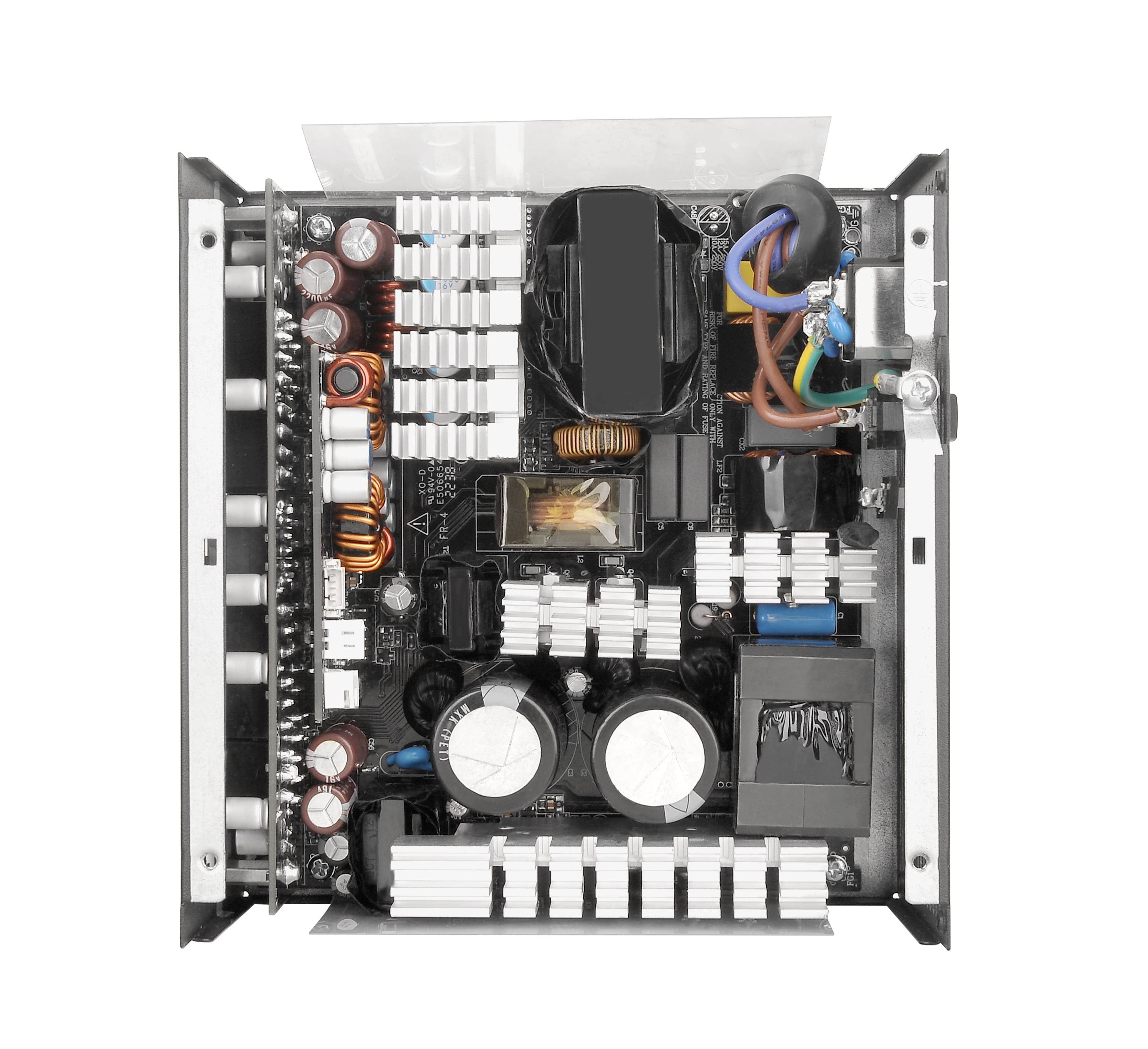 Internal view of a computer power supply unit with various electronic components and heat sinks arranged within an enclosure.