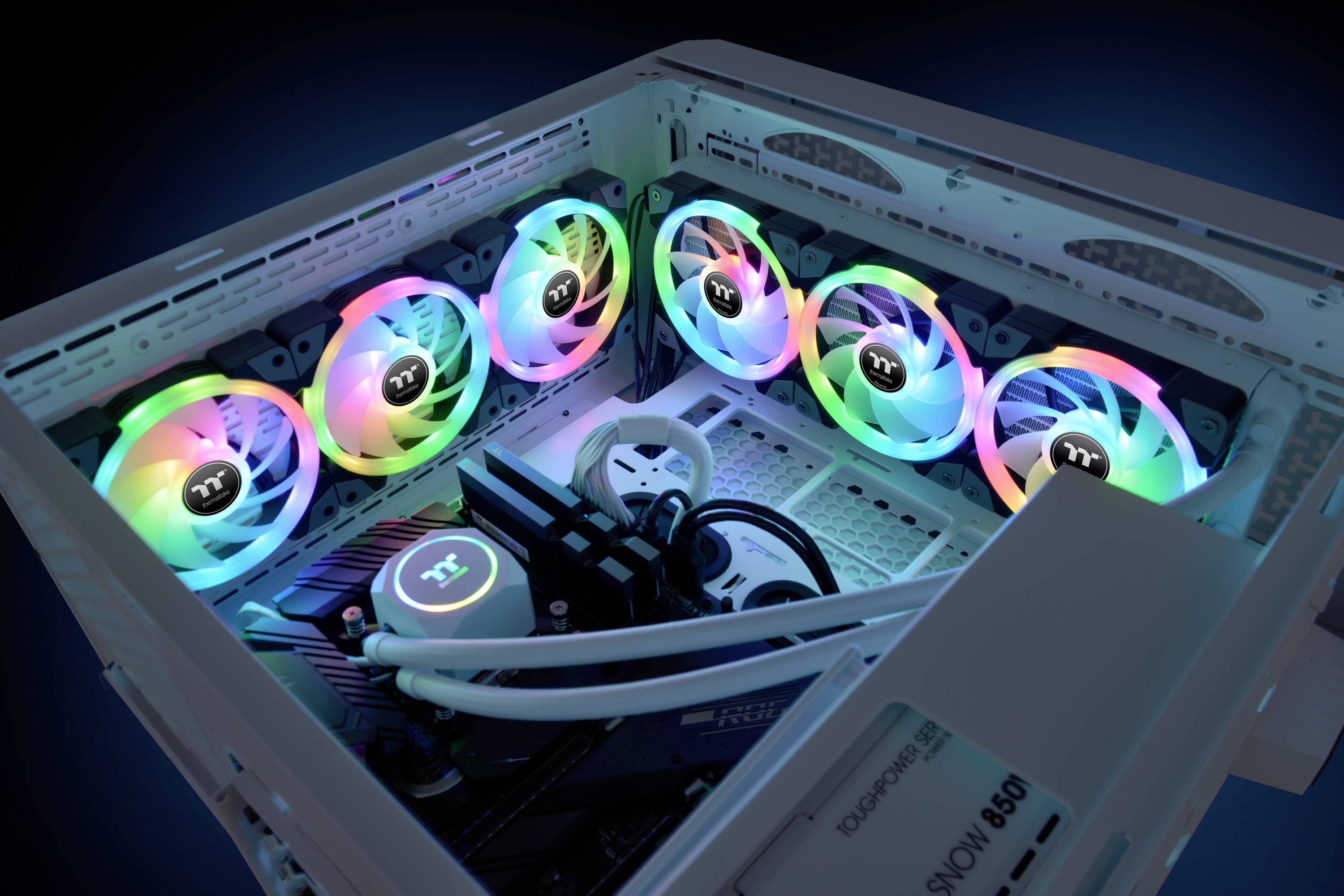 An open computer case with several brightly illuminated fans. The RGB lights create a colourful, technical ambience.