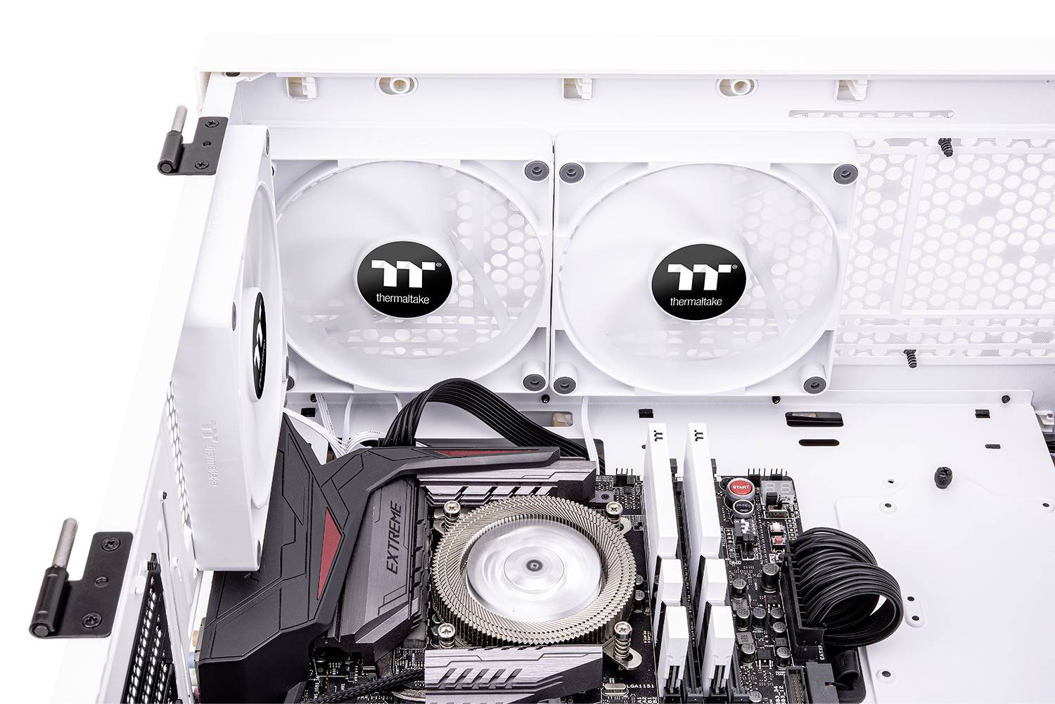 Interior view of a computer case with visible motherboard, CPU cooler and two large fans mounted on the case wall.