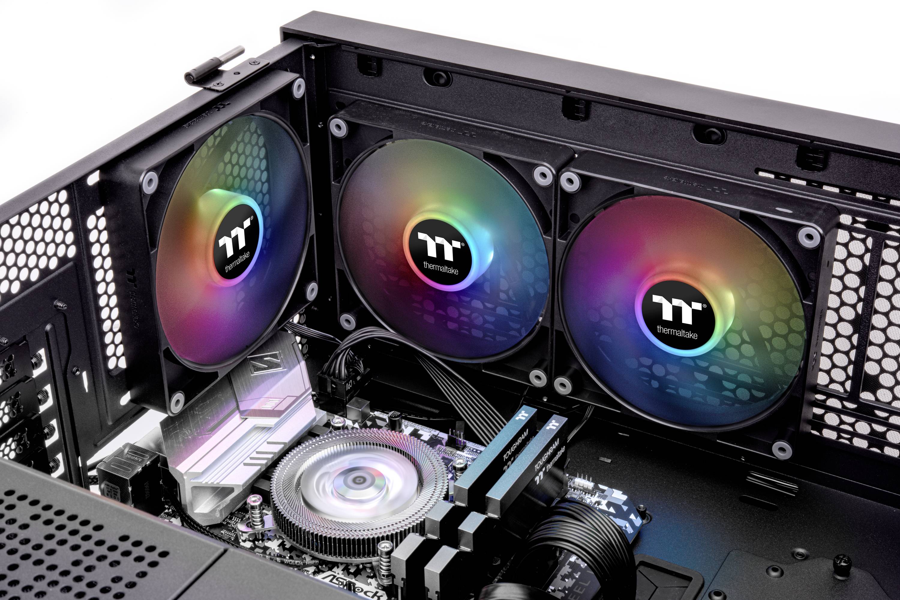 Open computer with visible internal components: three colourful fans on one side and a processor heatsink in the centre.