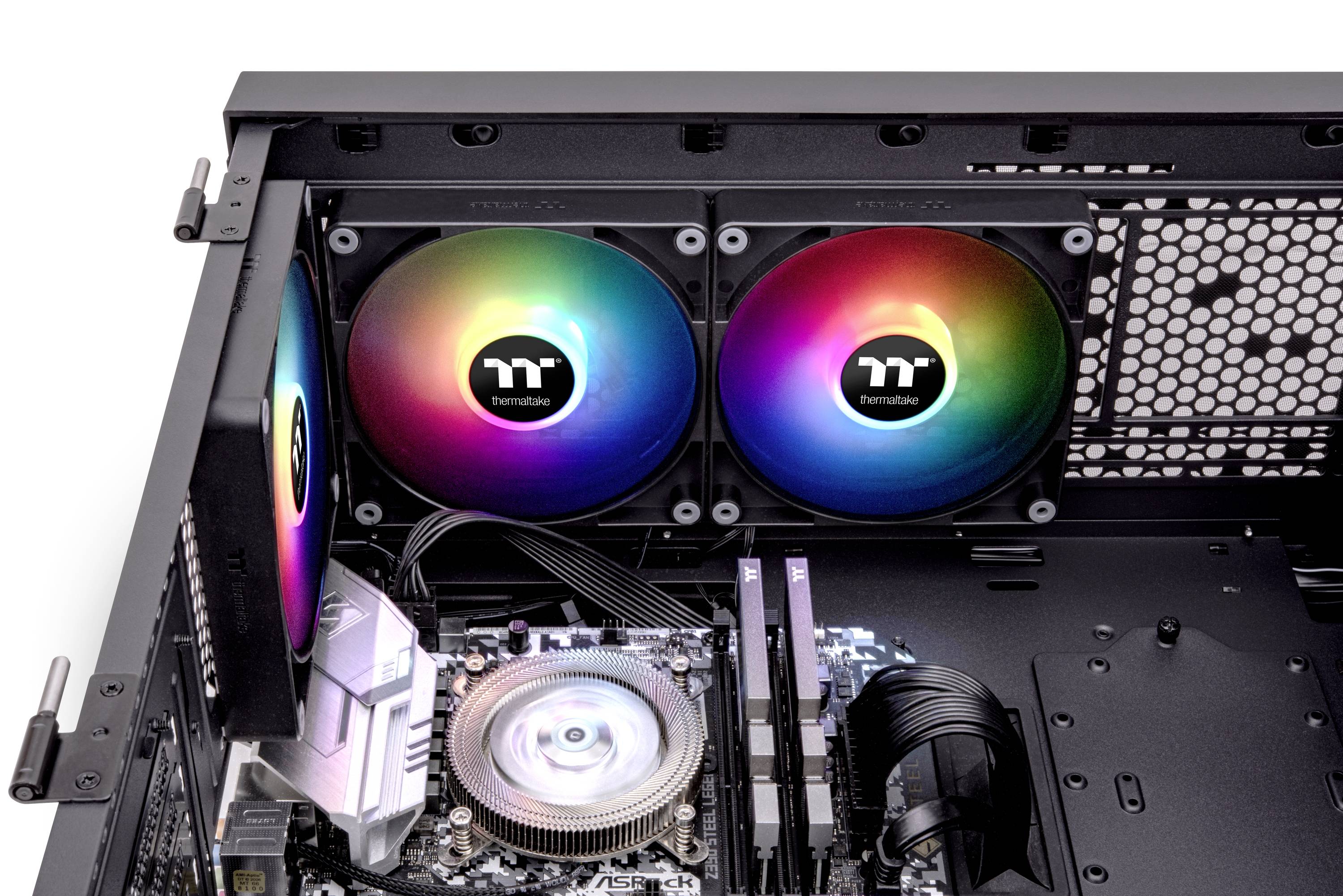 Interior of an open computer case with three RGB fans, a CPU with a heatsink and two RAM sticks on the motherboard.