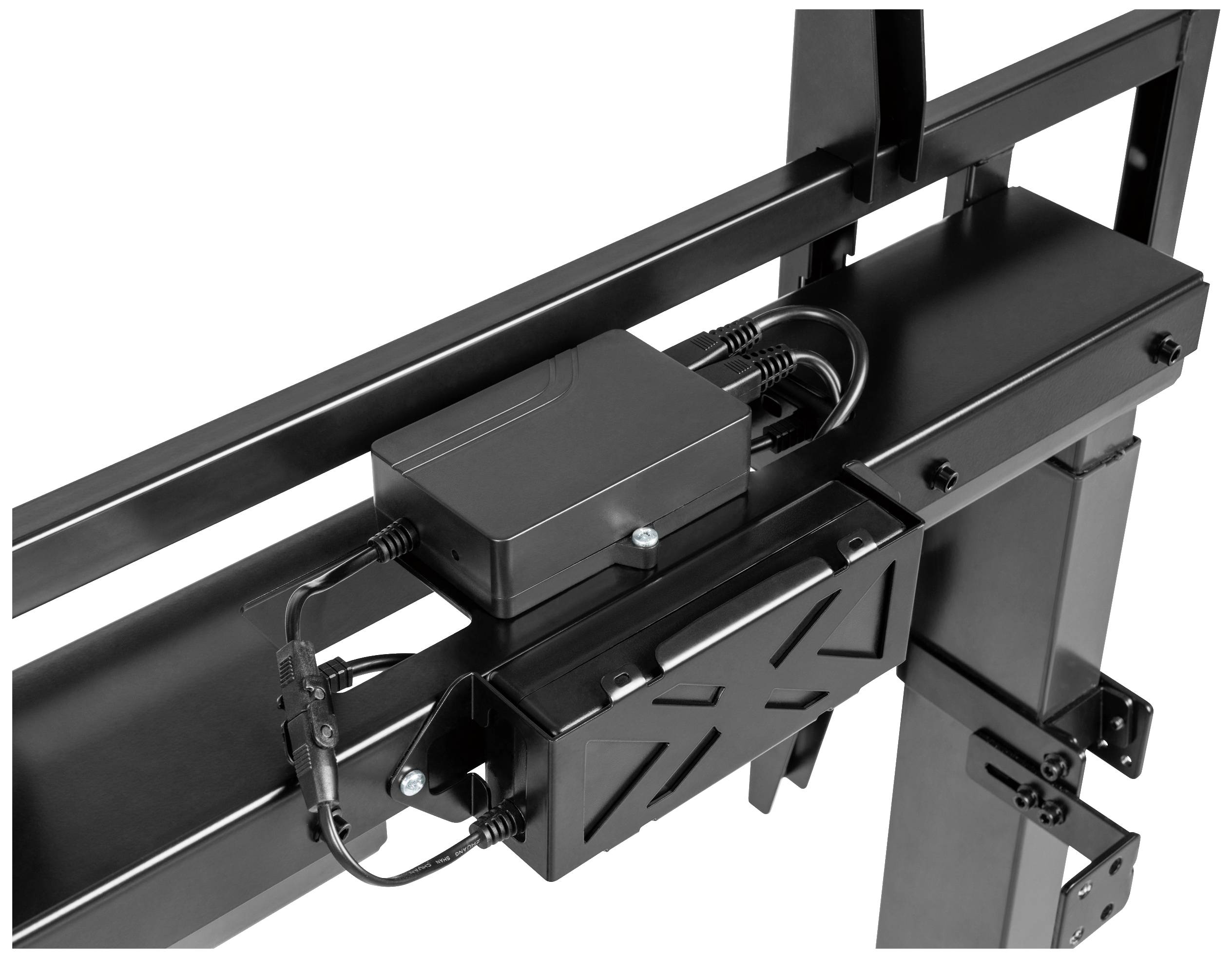 Close-up of a black electric mechanism with cables and a small housing for height adjustment of a table frame.