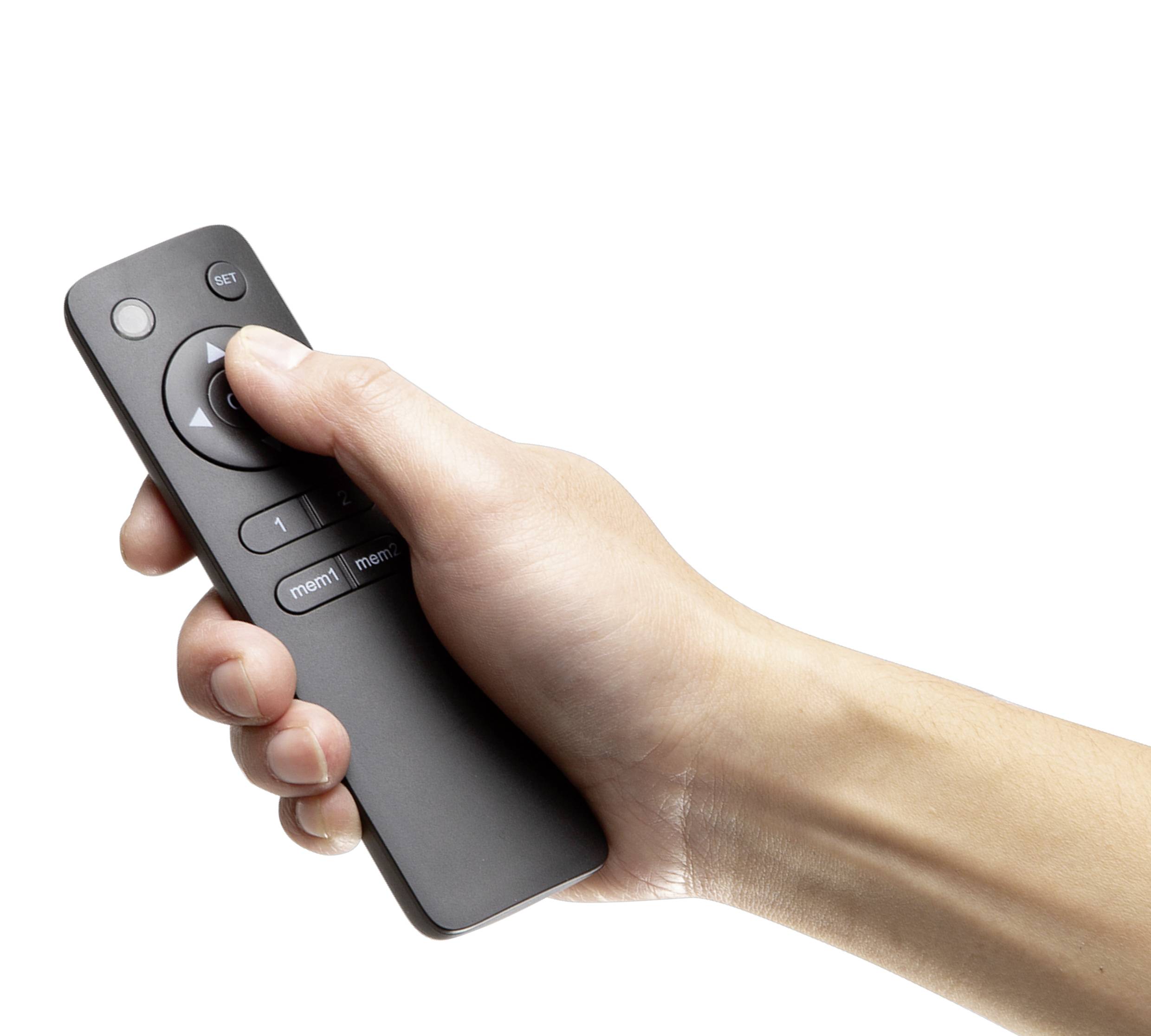 A hand is holding a black remote control.