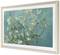 A painting depicts a blossoming almond tree with white flowers against a turquoise sky.
