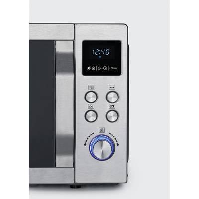 Close-up of a microwave with a stainless steel front and digital display. Shows the time as 12:40. Four function buttons and a large rotary dial are present.