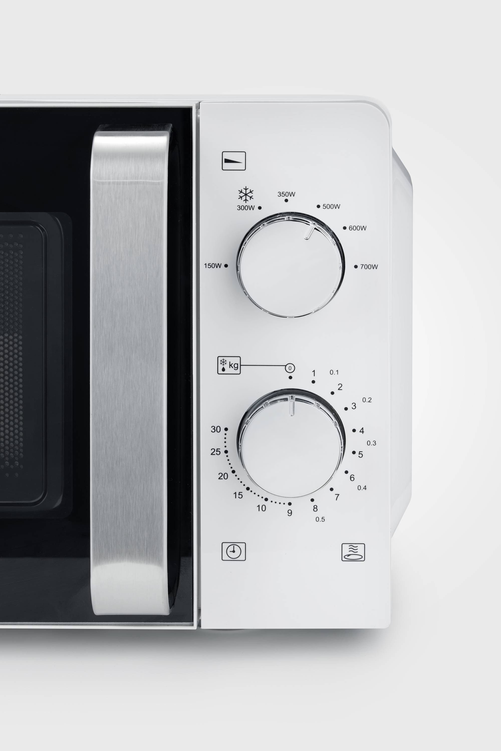 Part of a white microwave with two rotary controls and symbols. Upper dial shows power levels, lower dial is a timer.