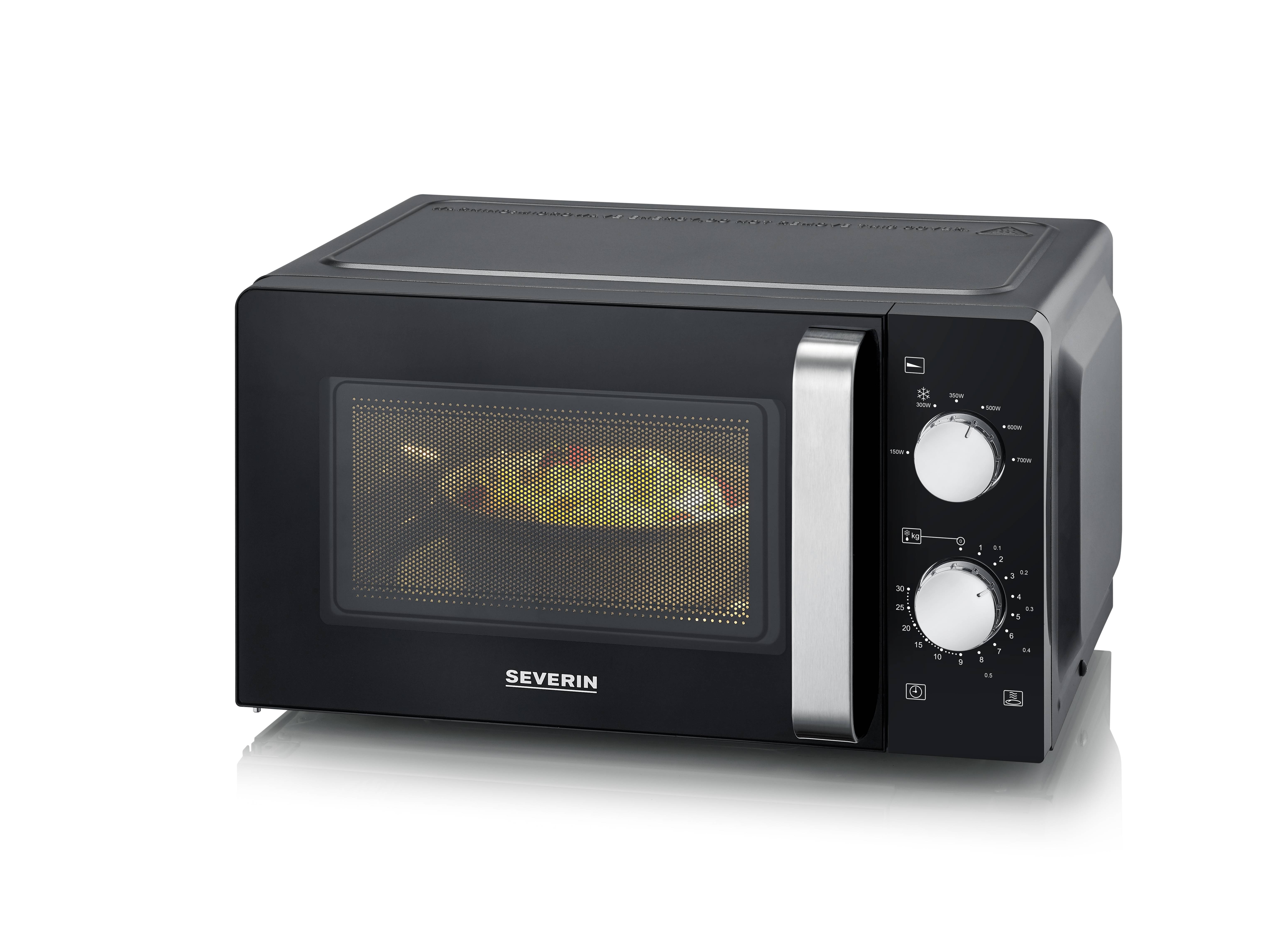 Black microwave with two control knobs on the right side. A dish is being heated inside. Brand 'Severin'.