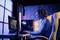 A woman is sitting at a desk playing a video game on a computer. A microphone hangs in front of her. The environment is colourfully illuminated.