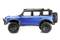 Blue toy off-road vehicle in side profile against a white background, with a large black tyre and plastic roof.