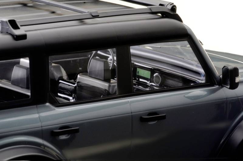 Off-road vehicle with a dark roof rack and tinted windows; interior with black leather upholstery visible.
