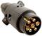 A black electric plug with six golden contacts, shown in a close-up view. The plug is for trailer connections.