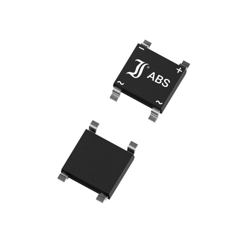 Two electronic components, square, black, with metal contacts, one labelled 'ABS' with polarity symbols.