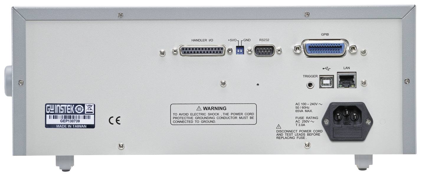 Rear view of an electronic device with multiple ports and a warning notice. Upper section: serial, parallel, and LAN ports. Lower section: power connection and switch.
