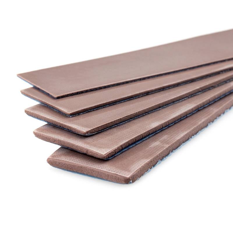 Several brown leather strips neatly stacked.