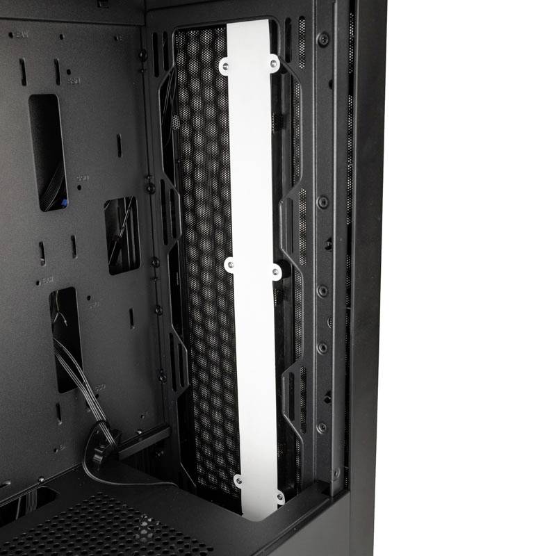 Open computer case with visible space for component mounting; a vertical white element separates two areas.
