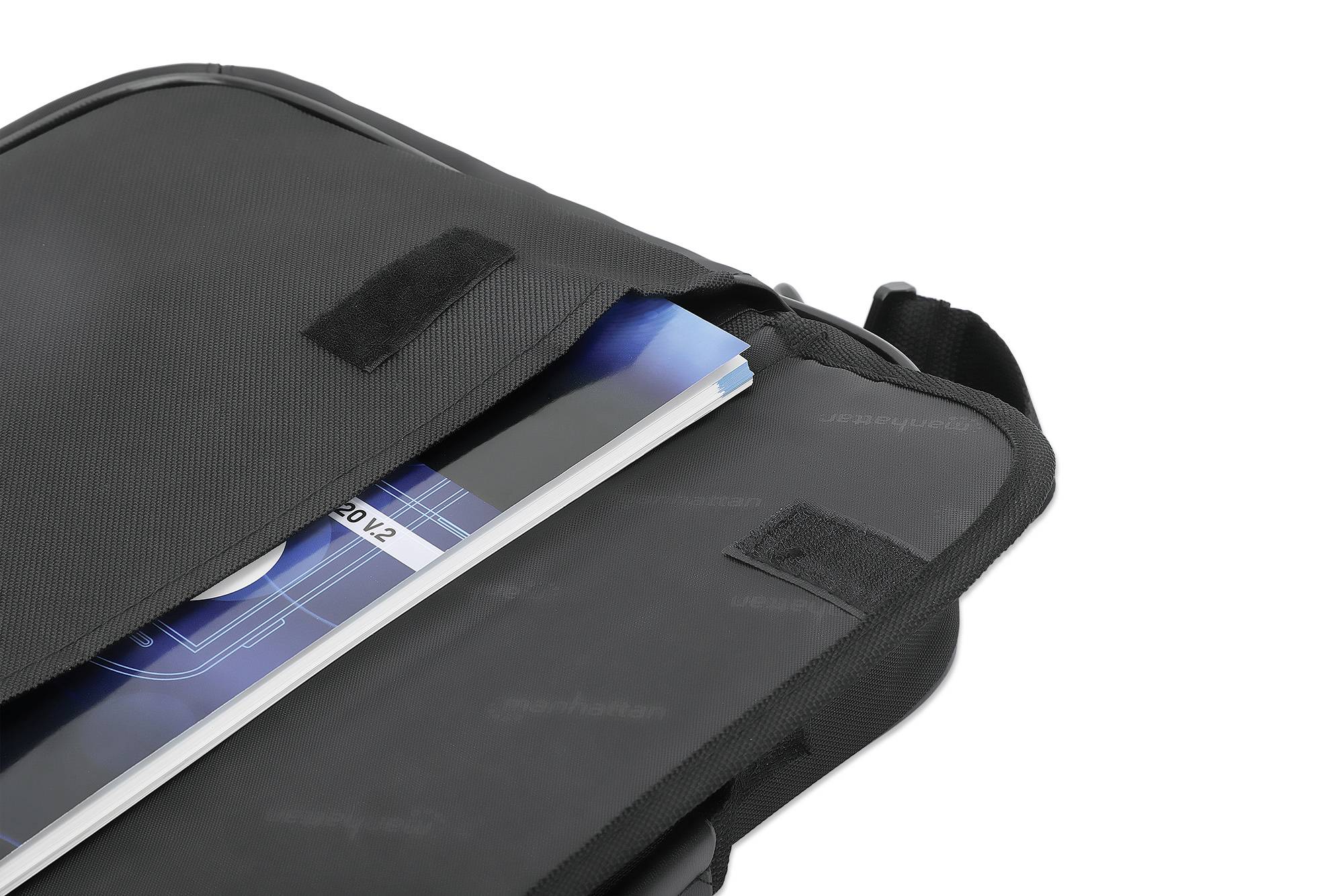 A black bag, partially open, with a blue notebook or book protruding from the bag.