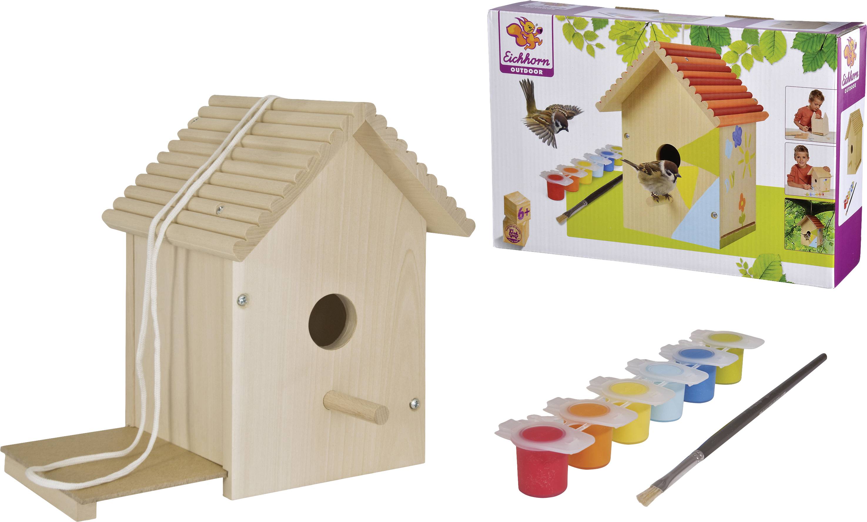 A DIY bird house painting kit. Contains an untreated wooden house, six paint pots, a brush, and an example packaging.