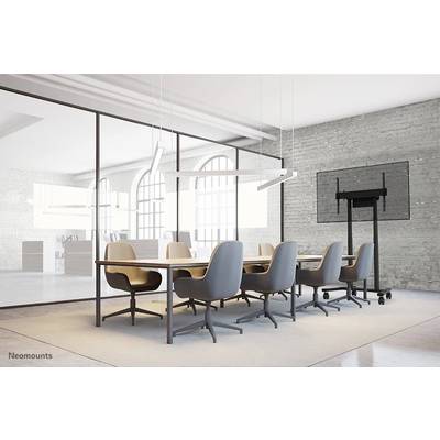 A modern conference room with a large table, eight chairs, a flat-screen monitor on the wall and large windows in the background.