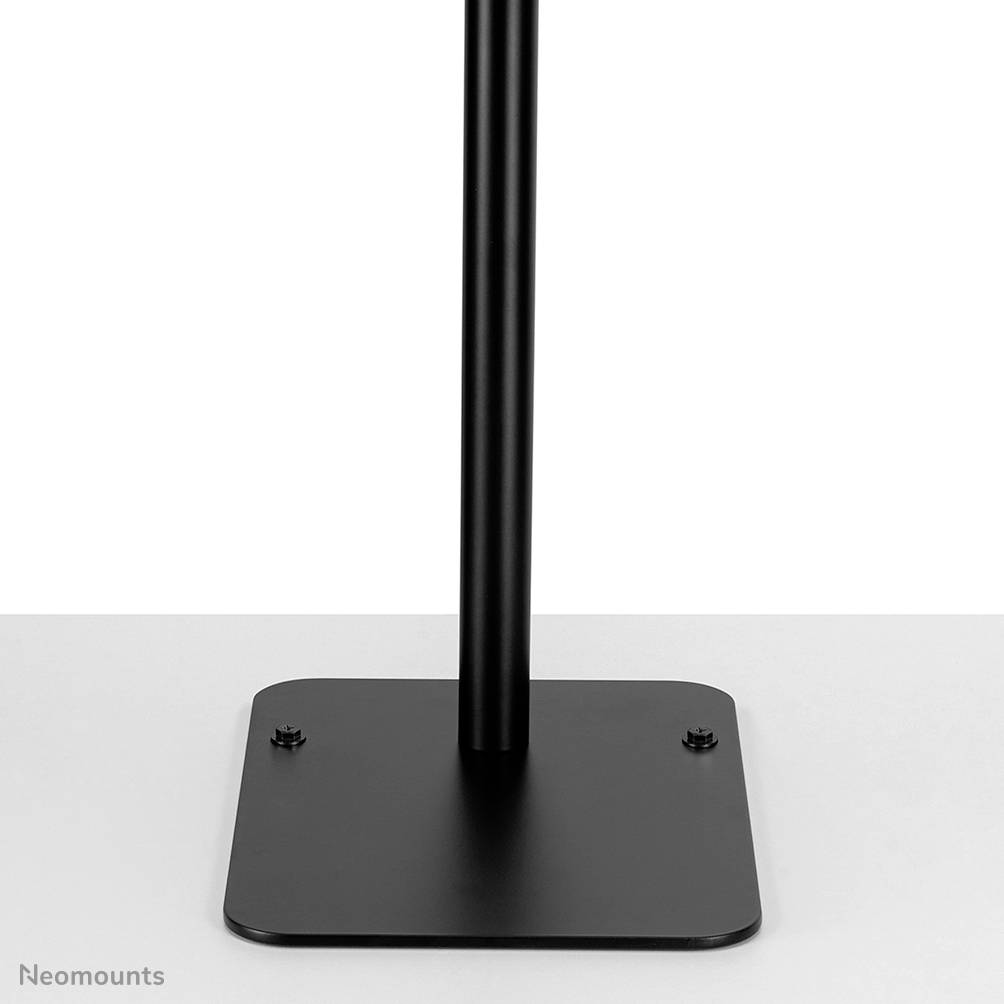 A black metal stand with a rectangular base and vertical rod, standing on a flat, grey surface.