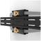 'Neomounts SELECT TV wall mount, fixed to a wall, displaying black metal struts with golden elements and grey straps.'