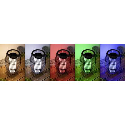 Five pictures show a lantern illuminating white, red, green, blue, and purple in sequence, standing on a wooden surface.
