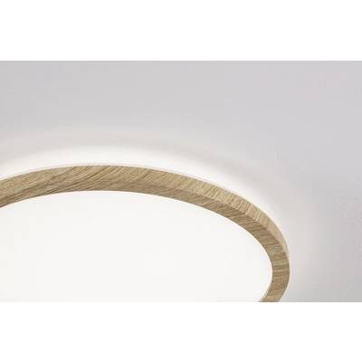 Round ceiling light with wooden frame in a bright room. Lampshade glows softly and creates a modern, minimalist ambience.