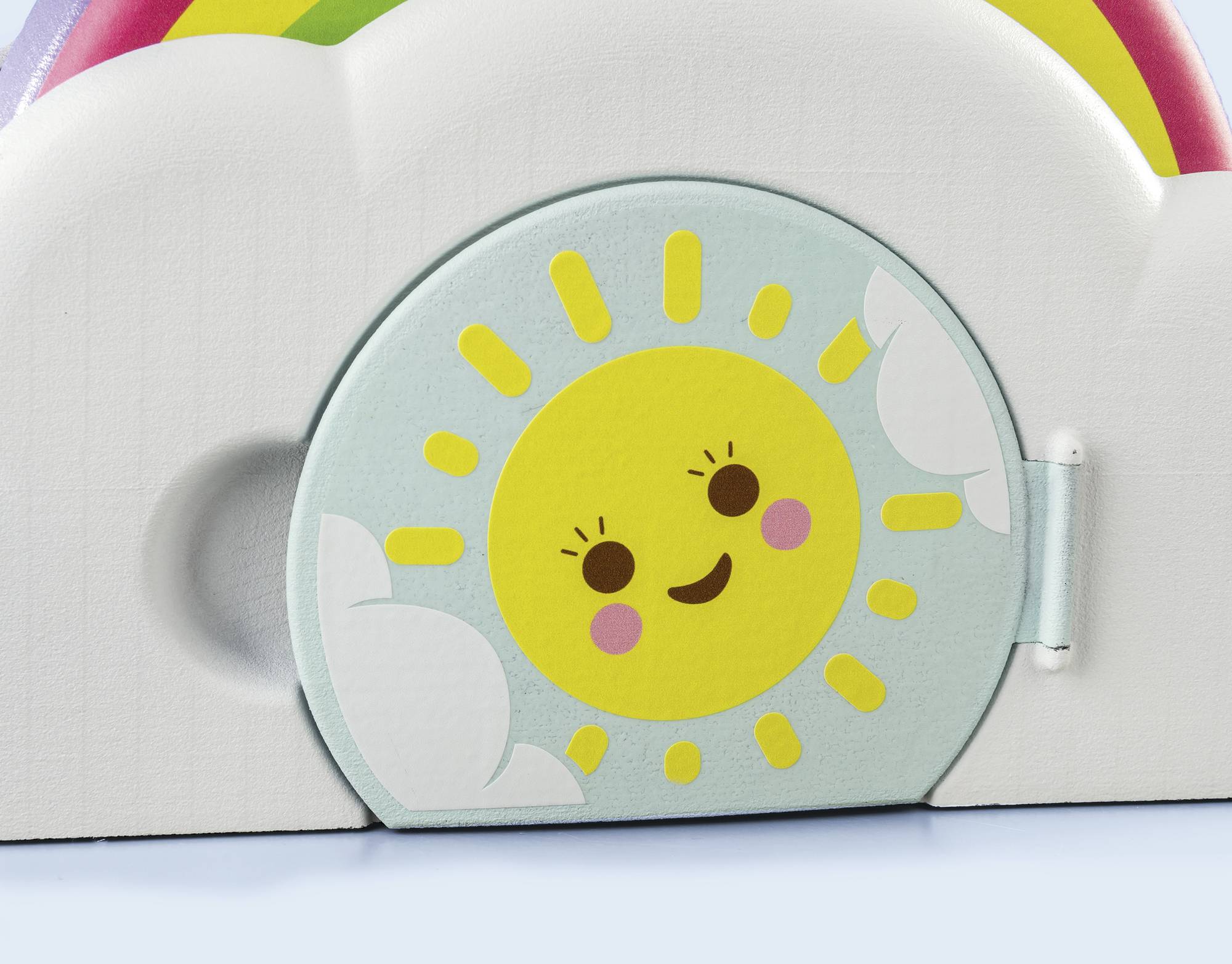 Colourful toy depicts a smiling sun with rosy cheeks in a cloud, with a rainbow above. A cheerful children's motif.