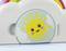 Colourful toy depicts a smiling sun with rosy cheeks in a cloud, with a rainbow above. A cheerful children's motif.