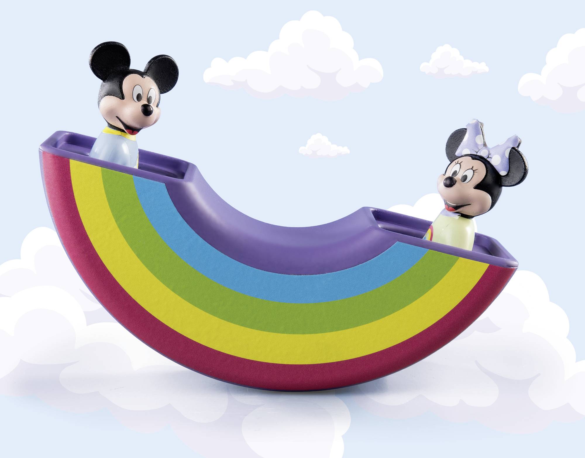 Two figures in a rocking rainbow toy against a cloudy background. One figure is wearing a bow on their head.