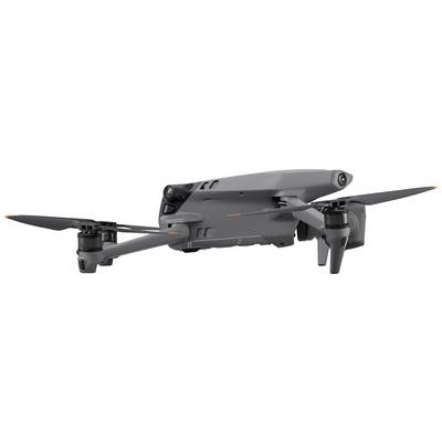 A grey drone with four rotors sitting on a table. It is ready for takeoff and displays a modern design with sleek lines.