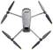 A grey quadcopter drone, viewed from above, on a white background.