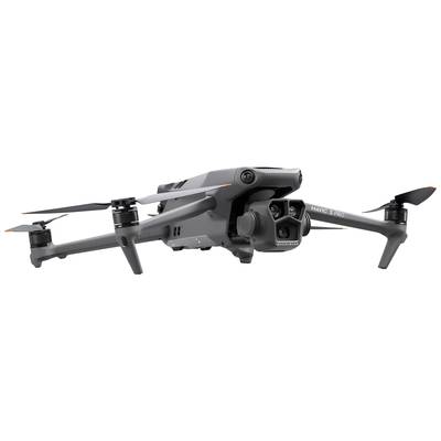 Grey drone with four rotors and camera. Side view shows technical details and aerodynamic design. Consider drone deployment.