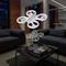 A drone hovers in a modernly furnished living room above a marble coffee table between two dark sofas.