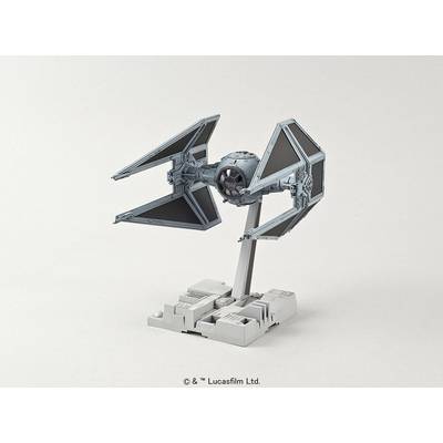 A model of a TIE Fighter on a grey base. The spacecraft has a characteristic, angular design with solar panels.