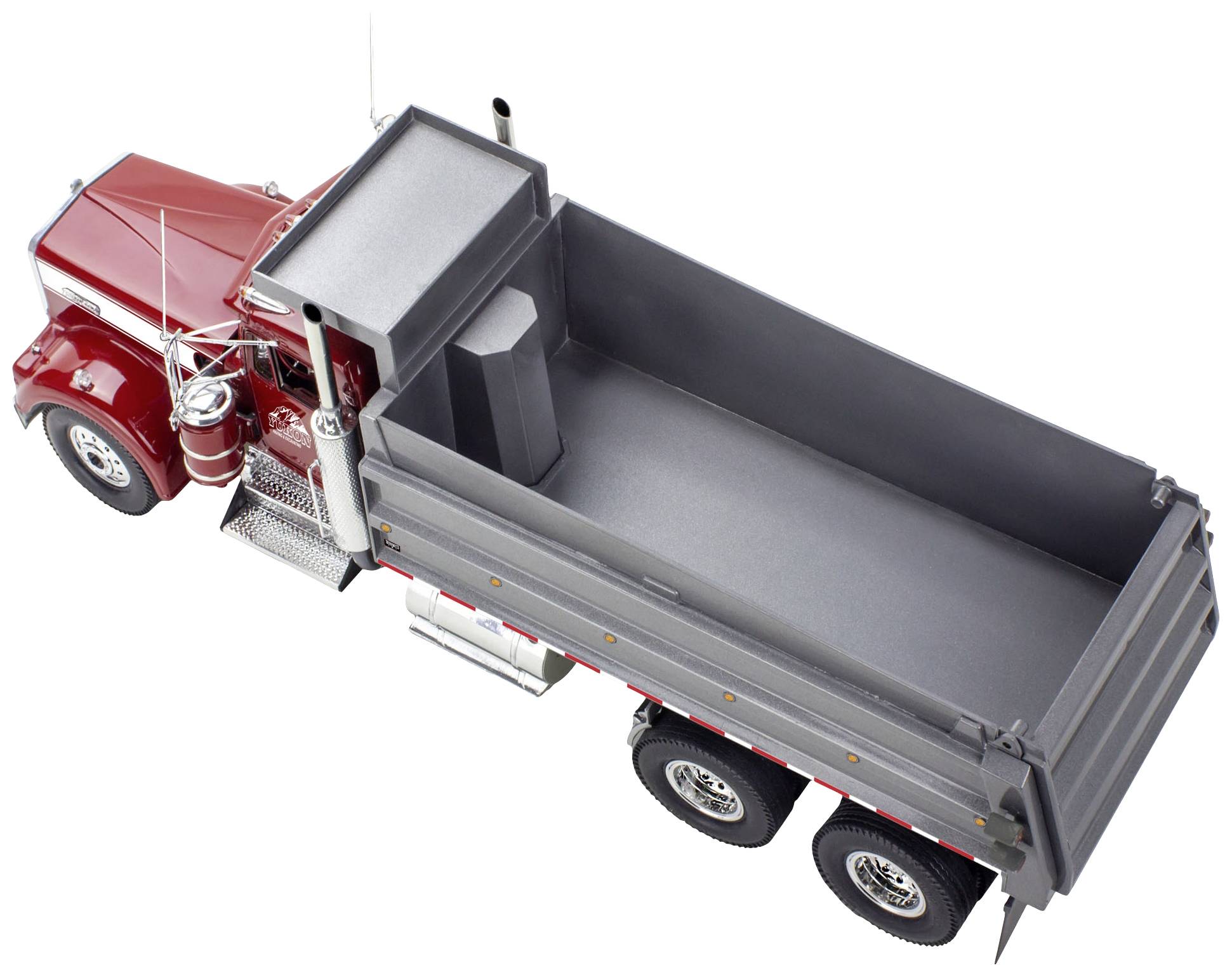 A red lorry with an open grey cargo area, photographed from above. The truck is massive and has a robust construction.