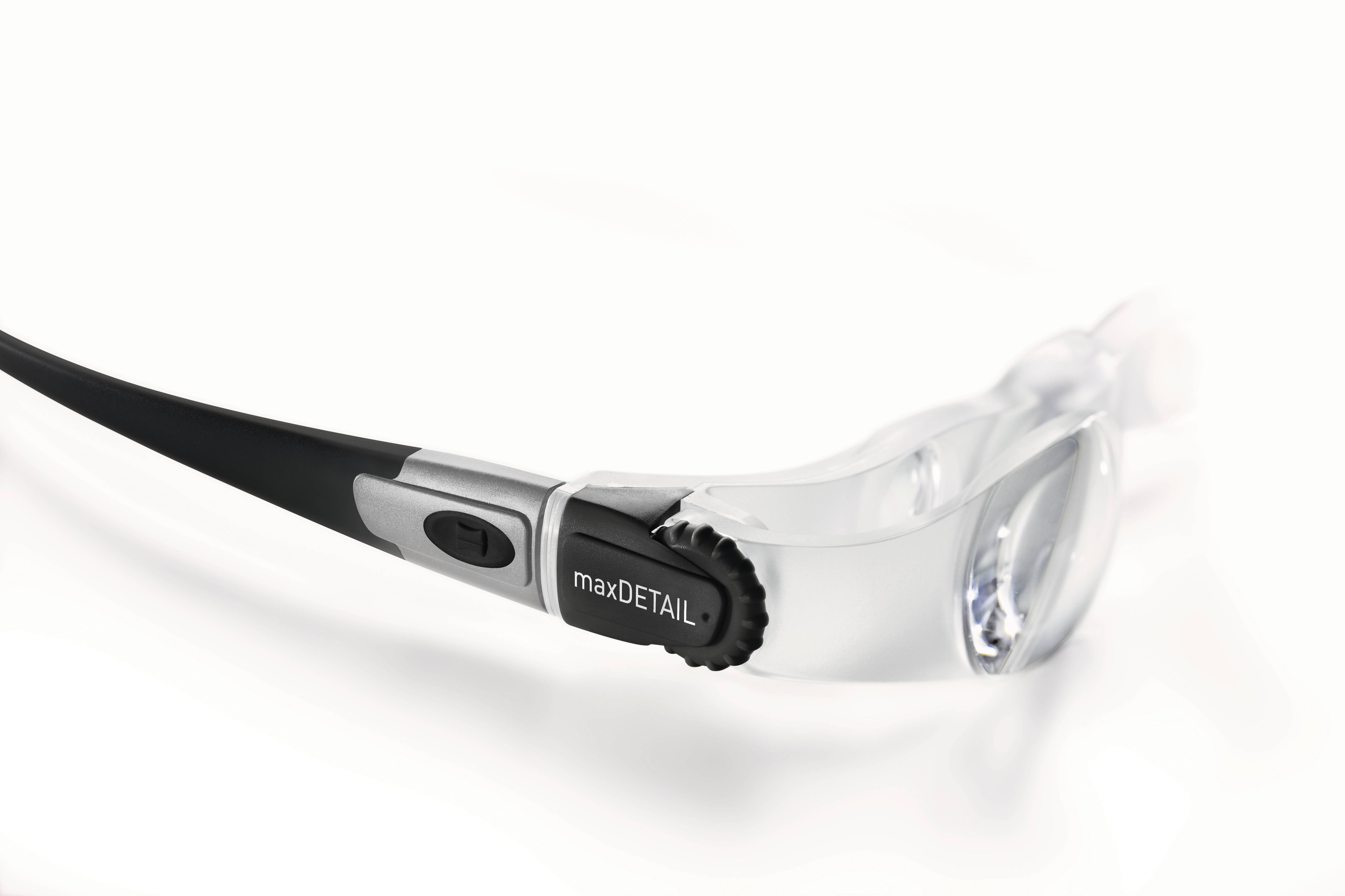 A black pair of glasses with silver details and the inscription 'maxDETAIL' on the arm, against a white background.