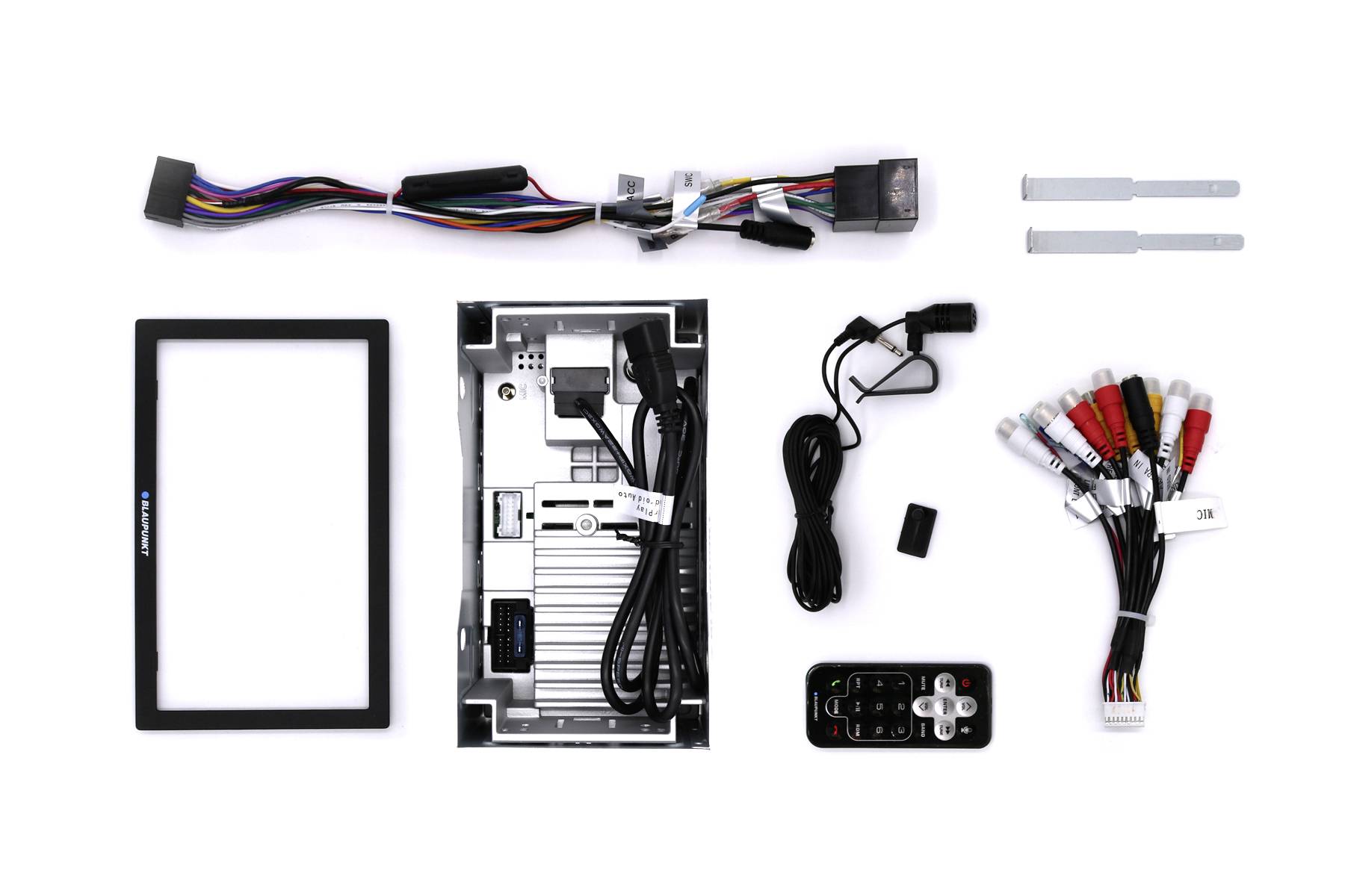 Electronic device parts and accessories lie on a white background. Includes cables, remote control, and a casing.