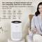 A woman sits on the sofa and looks at a Bosch air purifier beside her. The text explains its effectiveness against pollutants up to 37.5 m².