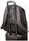 A rucksack with padded straps is securely attached to a wheeled suitcase, with the telescopic handles of the suitcase visible.