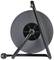 A blank cable drum holder with handle, front view. The holder has a black frame and a grey cylinder.