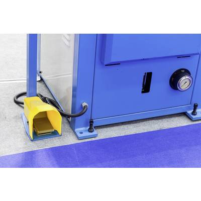 Blue-grey machine with a yellow foot pedal, presumably industrial. Device is standing on grey floor with a blue carpet strip.