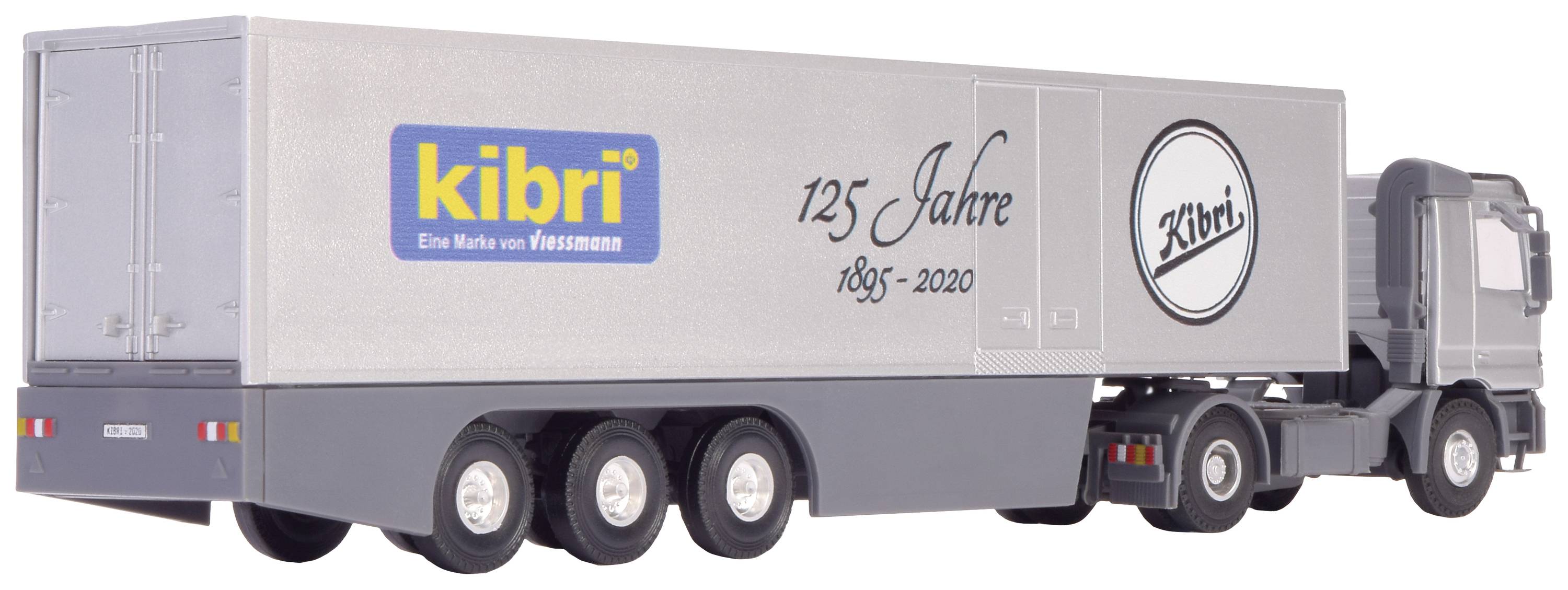 A grey model lorry with 'kibri' inscription and '125 Years 1895-2020' on the trailer, with a circular logo underneath.