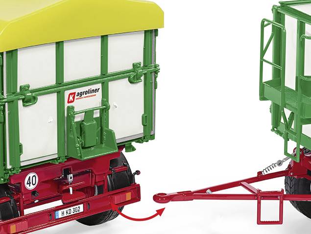 A green trailer with a yellow roof is connected to another vehicle by a red drawbar. Number plate: 'H KQ 302'.