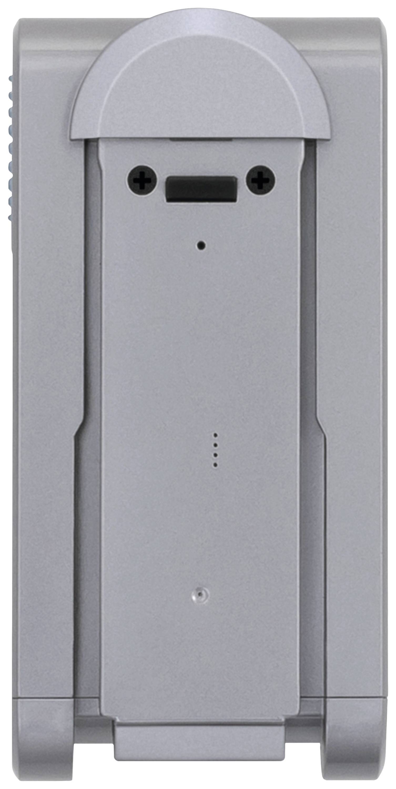 A silver battery charging station with two circular charging indicators on top and a sliding drawer for battery insertion.