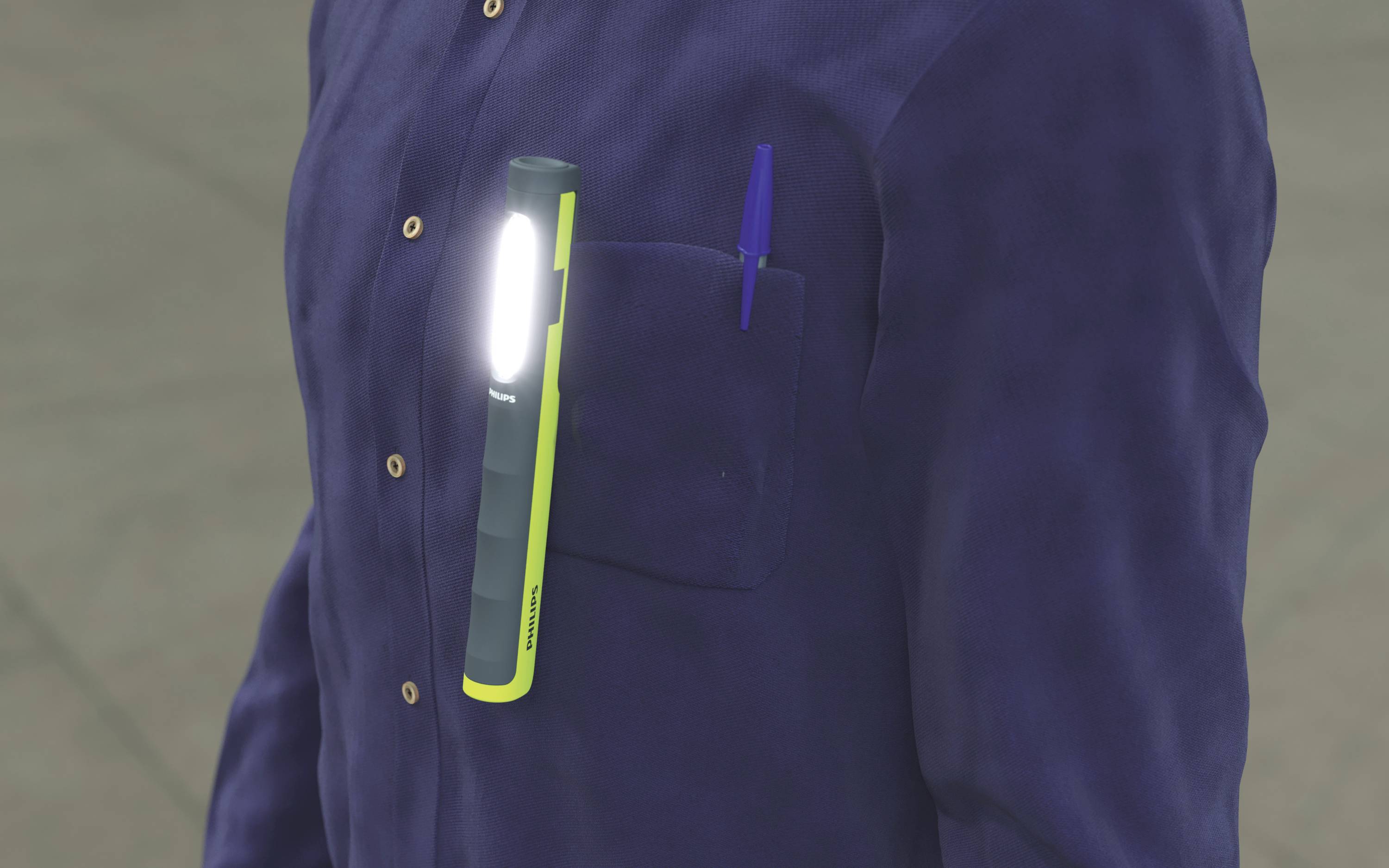 A person is wearing a navy blue jacket with a bright torch and a blue pen in the breast pocket.